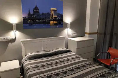 Cama o camas de una habitación en Apartamentos El Templo Suites
