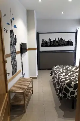 Cama o camas de una habitación en Apartamentos El Templo Suites