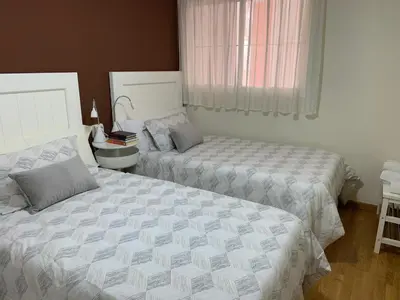 Cama o camas de una habitación en Alojamiento en Villanueva Serena 2 dormitorios