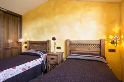 Cama o camas de una habitación en Casa Rural & SPA Mirador de la Covatilla