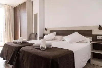 Cama o camas de una habitación en Mesón Hostal La Cabaña