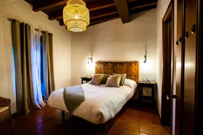 Cama o camas de una habitación en Apartamentos Puente de la Judería