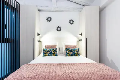Cama o camas de una habitación en Apartamentos Hervás Suites