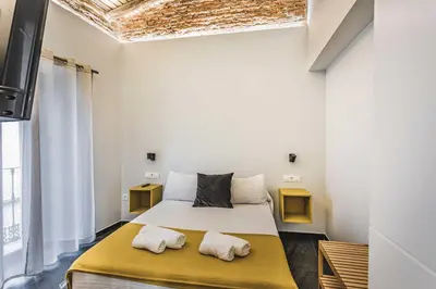 Cama o camas de una habitación en Apartamentos Cáceres Central Suites