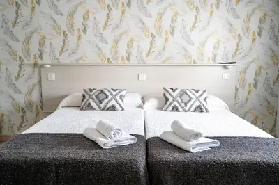 Cama o camas de una habitación en Hostal Plaza de Italia