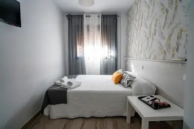 Cama o camas de una habitación en Hostal Plaza de Italia