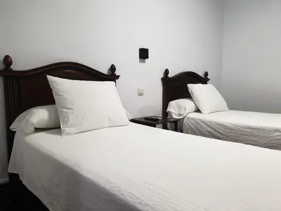 Cama o camas de una habitación en Hostal Cuzco
