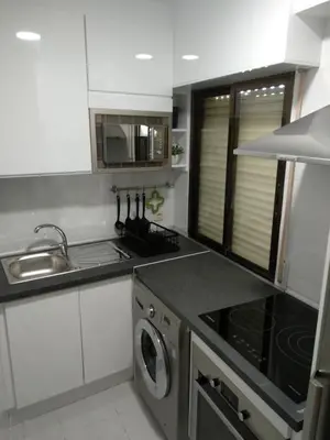 Una cocina o zona de cocina en los pisitos de El Barraco 2