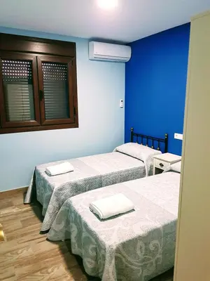 Cama o camas de una habitación en APARTAMENTOS LOS ÁLAMOS