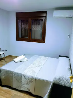 Cama o camas de una habitación en APARTAMENTOS LOS ÁLAMOS