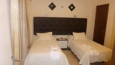 Cama o camas de una habitación en Hostal Cerezo