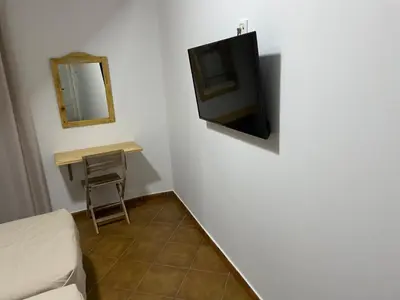 Una televisión o centro de entretenimiento en Hostal Rio