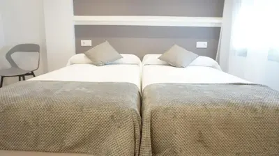 Cama o camas de una habitación en Hostal León