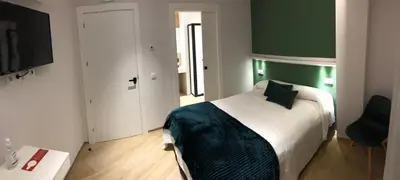 Cama o camas de una habitación en Hostal León