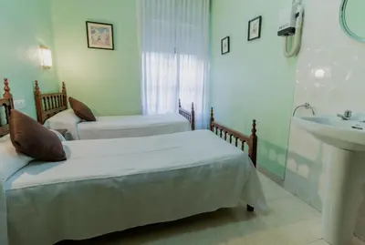 Cama o camas de una habitación en Pensión Virginia by Vivere Stays