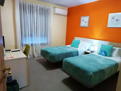 Cama o camas de una habitación en Hotel Alma Rosa