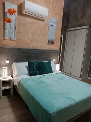 Cama o camas de una habitación en Hotel Alma Rosa