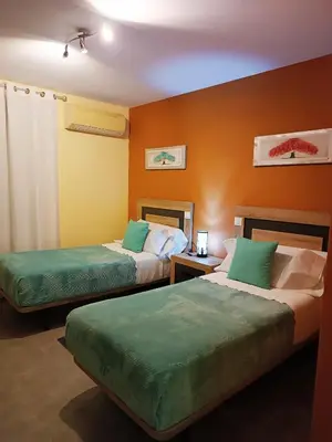Cama o camas de una habitación en Hotel Alma Rosa