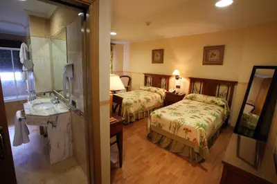 Cama o camas de una habitación en Hotel El Pentágono