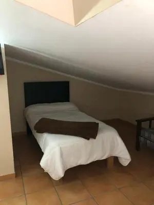Cama o camas de una habitación en Hostal La Caballeriza