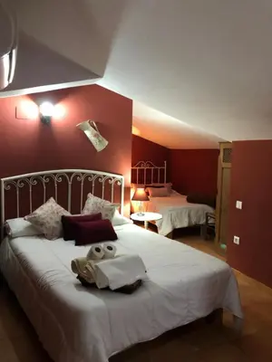 Cama o camas de una habitación en Hostal La Caballeriza