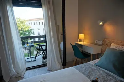 Cama o camas de una habitación en Apartamentos IMPLUVIUM Mérida