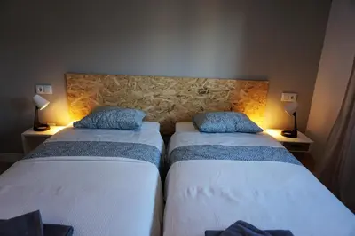 Cama o camas de una habitación en Apartamentos IMPLUVIUM Mérida