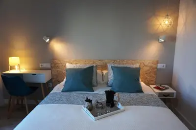 Cama o camas de una habitación en Apartamentos IMPLUVIUM Mérida