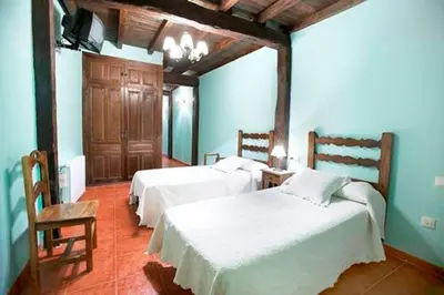 Cama o camas de una habitación en CASA RURAL LOS PORTALES Valle del Jerte