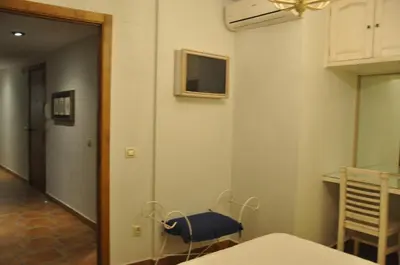 Una televisión o centro de entretenimiento en Apartamentos Boutique Doña Maria La Brava