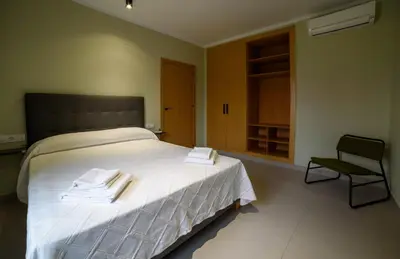 Cama o camas de una habitación en Apartamentos Rurales La Gloria de Yuste