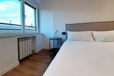 Cama o camas de una habitación en Apartamentos Celestina by gaiarooms