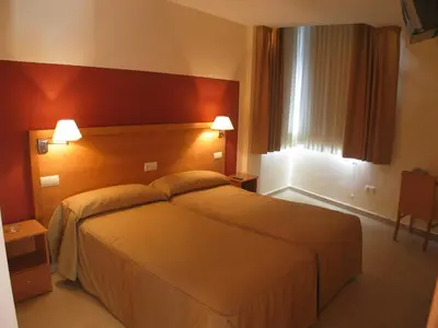 Cama o camas de una habitación en Hostal Ciudad de Cáparra