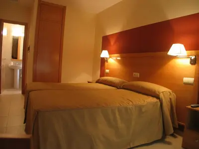 Cama o camas de una habitación en Hostal Ciudad de Cáparra