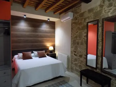 Cama o camas de una habitación en Apartamentos Suite Puerta del Jerte