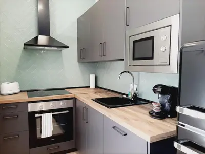 Una cocina o zona de cocina en Apartamentos Vega by gaiarooms