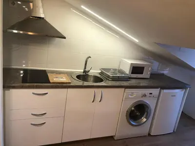 Una cocina o zona de cocina en APARTAMENTO TURISTICO ATICO LA TABERNA