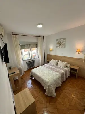 Cama o camas de una habitación en Hostal Argentina EN CACERES
