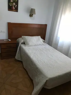 Cama o camas de una habitación en Hostal Argentina EN CACERES