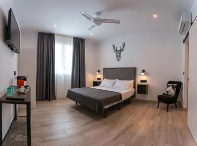 Cama o camas de una habitación en La Posada del Teatro H Boutique Parking Gratis