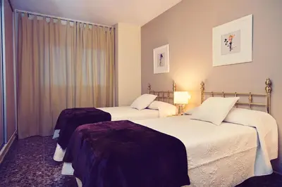 Cama o camas de una habitación en Apartamentos Turísticos Ceres Parking Gratis