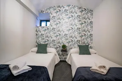 Cama o camas de una habitación en Apartamentos Turísticos Cáceres 