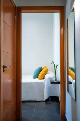 Cama o camas de una habitación en Apartamentos Turísticos Cáceres 