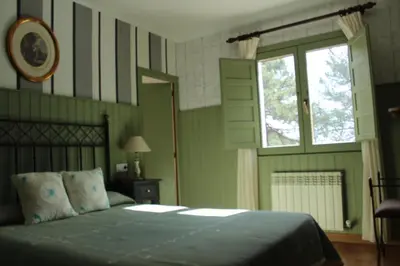 Cama o camas de una habitación en Hostal Fogón de Gredos