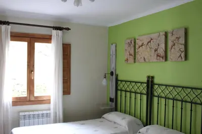 Cama o camas de una habitación en Hostal Fogón de Gredos