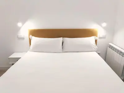 Cama o camas de una habitación en Apartamentos La Brava by gaiarooms