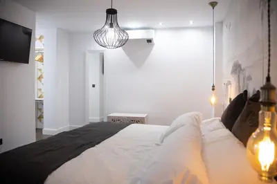 Cama o camas de una habitación en Apartamentos Boutique Cervantes