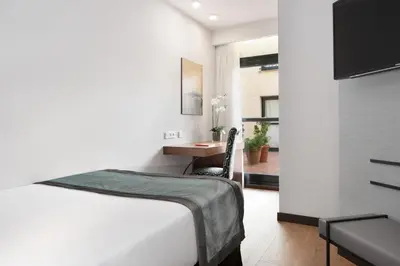 Cama o camas de una habitación en Dorma Agora Cáceres
