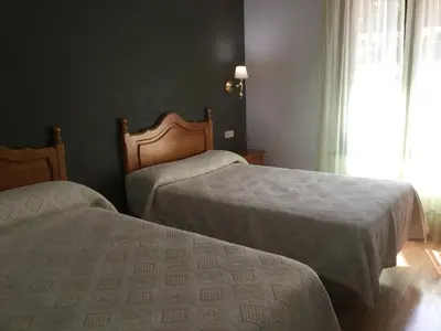 Cama o camas de una habitación en Hotel Cinco Castaños