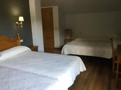 Cama o camas de una habitación en Hotel Cinco Castaños